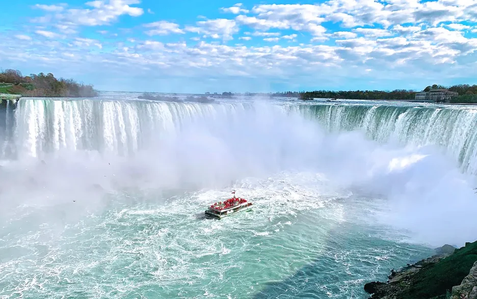 Niagara City Cruises boat tour approaching Horseshoe Falls with passengers on deck