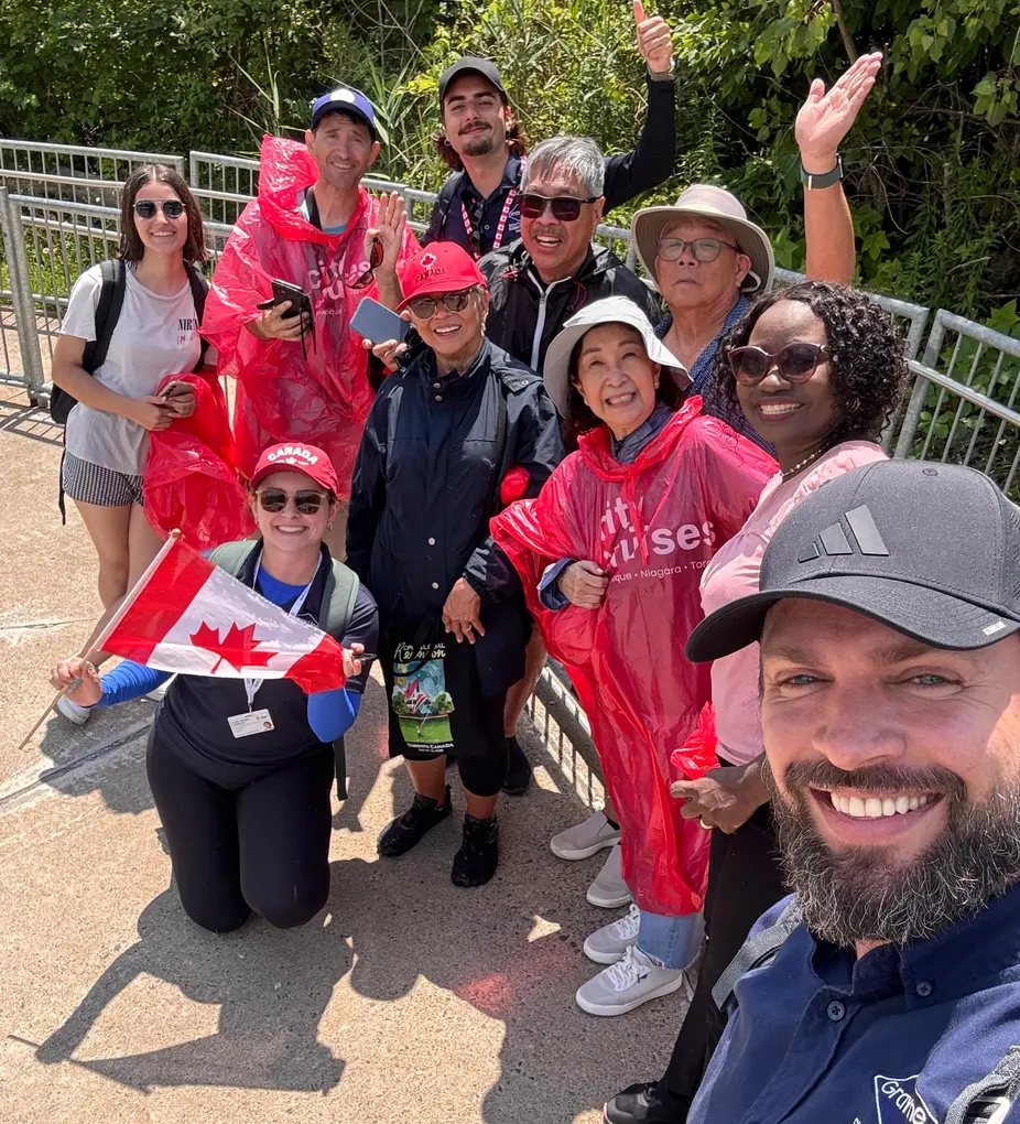 Group of tourists on guided walking tour at Niagara Falls Canada with scenic river views