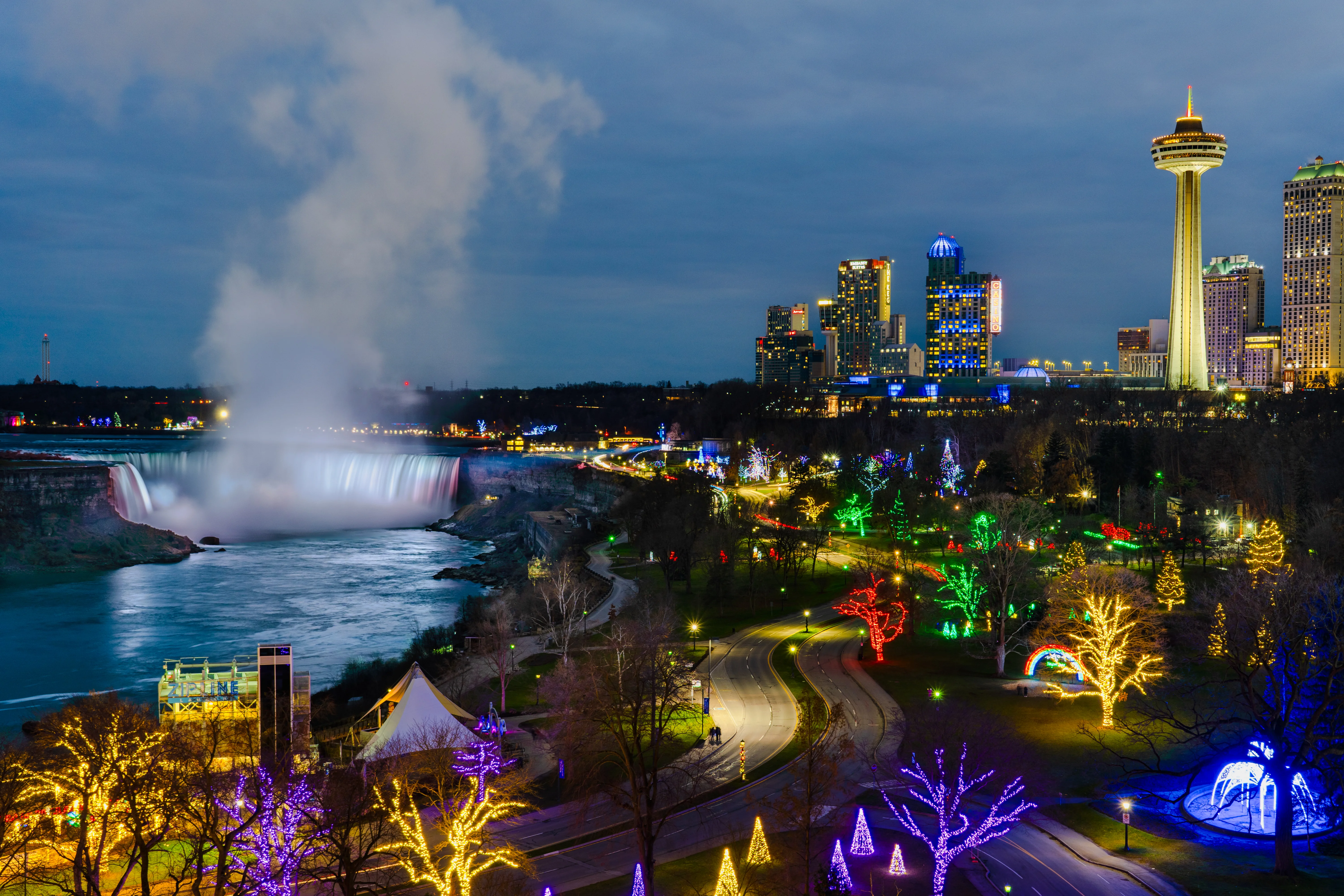 Wide skyline view of illuminated Niagara Falls during Winter Festival of Lights