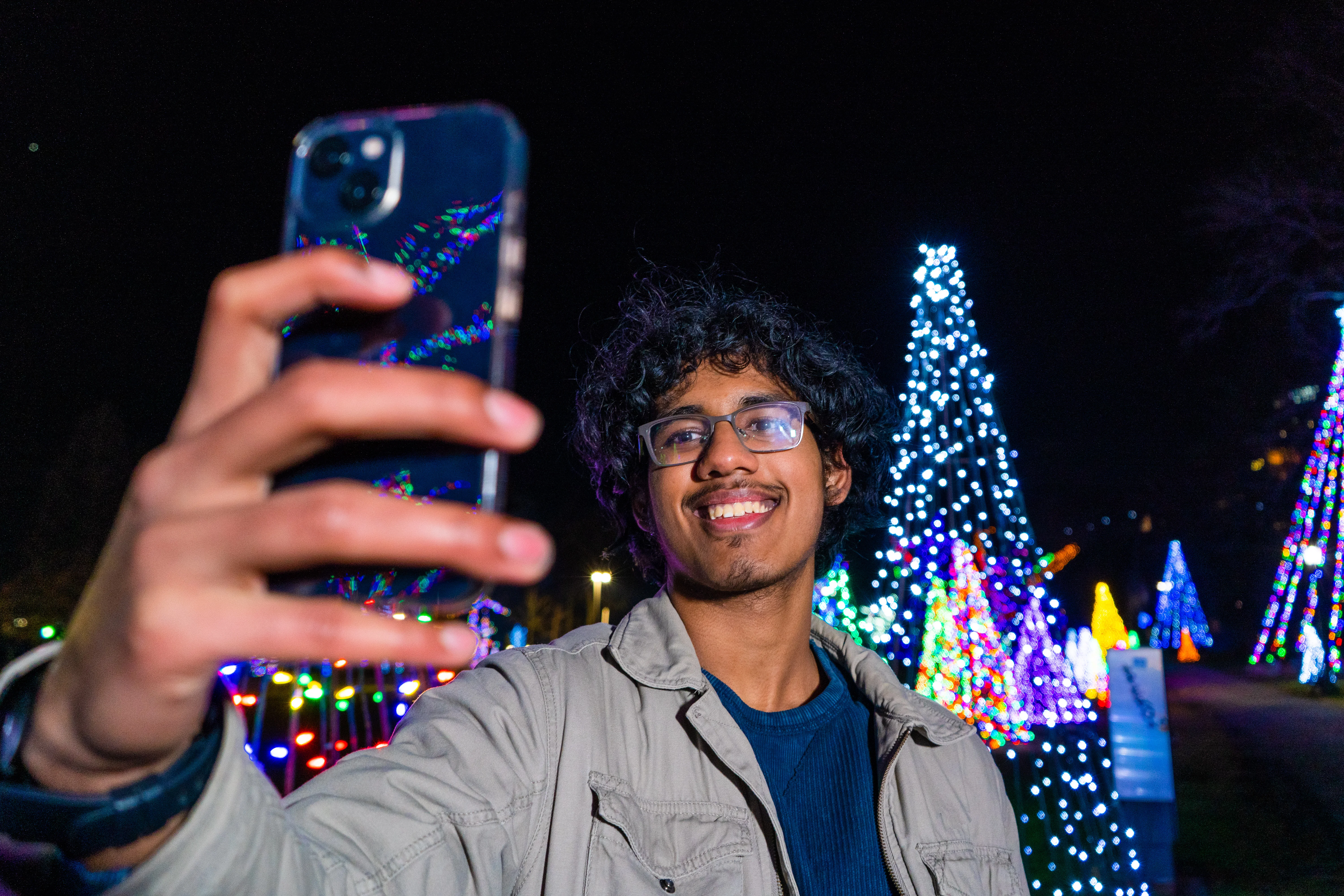 Tourist taking selfie at Winter Festival of Lights displays